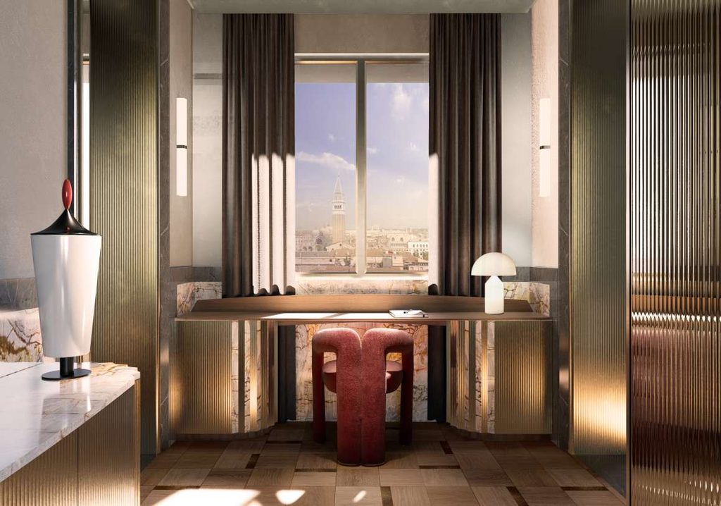 Elegant hotel vanity nook with ribbed details, a marble top desk, and a window framing a view of Venice’s cityscape and bell tower. top interior design firms in milan