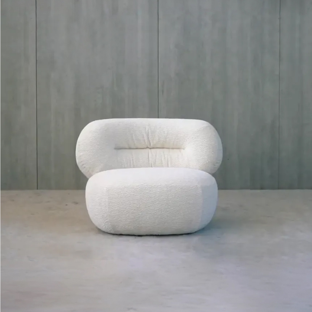 Close-up of bouclé fabric texture on a modern armchair in a stylish interior