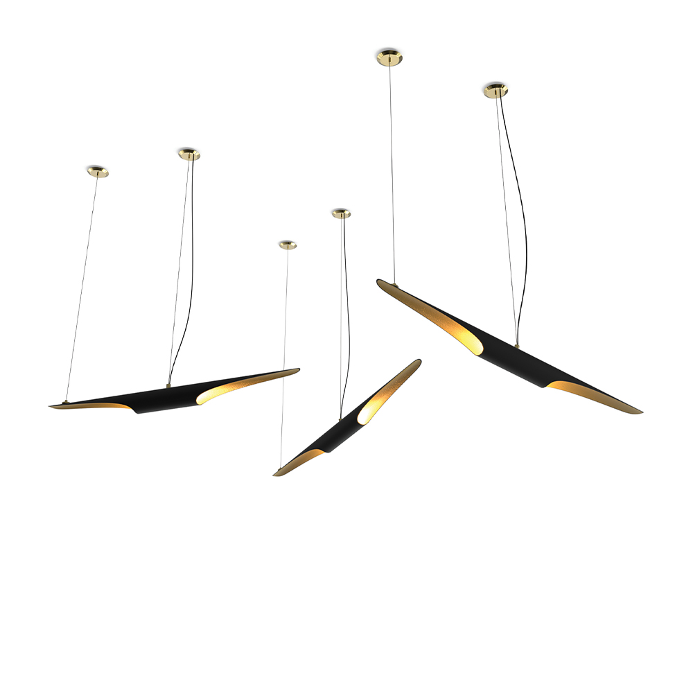 Set of modern tubular pendant lights in black with gold interiors against a white background.